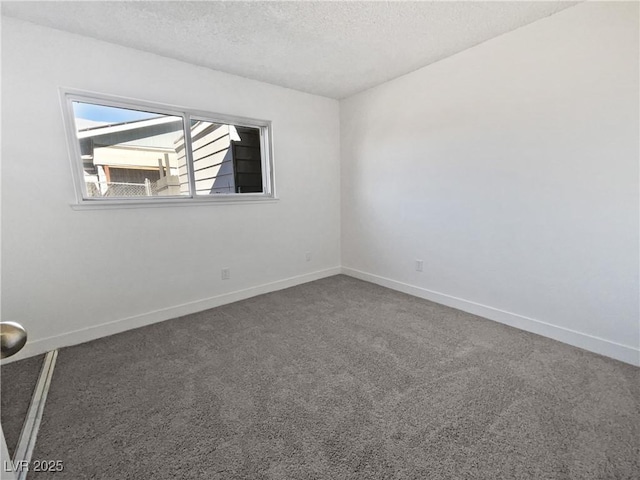 carpeted spare room featuring a textured ceiling