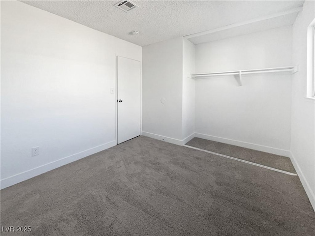 unfurnished bedroom with carpet, a textured ceiling, and a closet