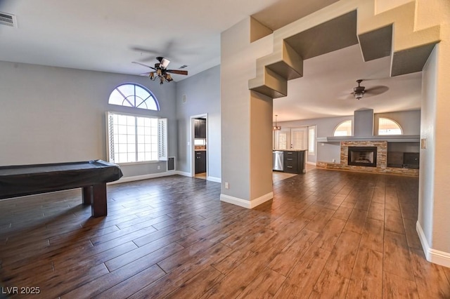 rec room with wood-type flooring, a stone fireplace, ceiling fan, and billiards