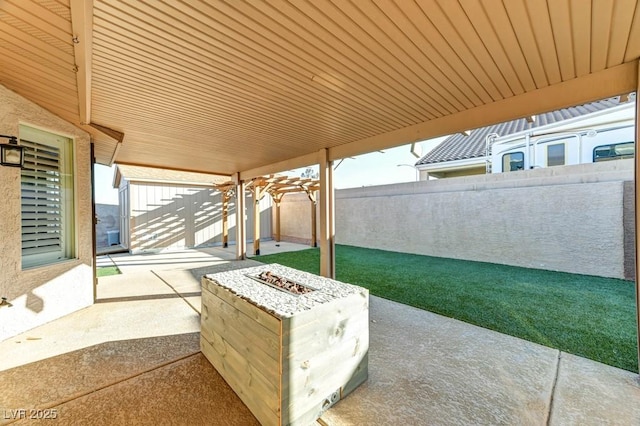 view of patio with a fire pit