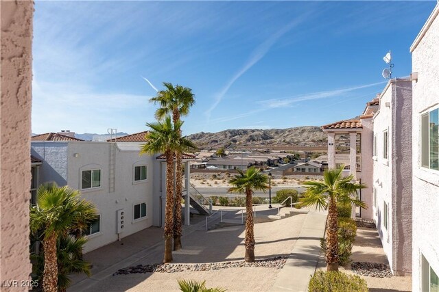 exterior space with stairway, a residential view, and a mountain view