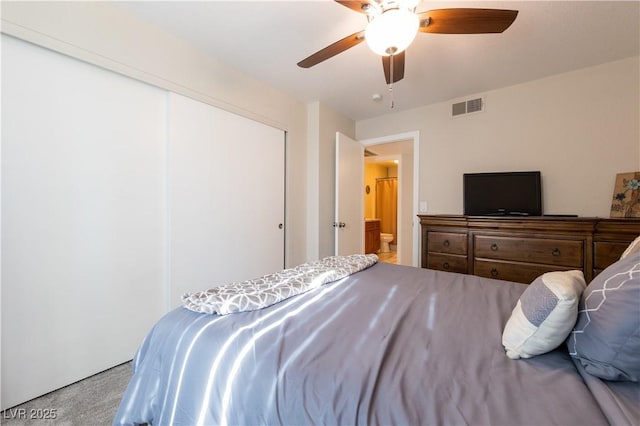 bedroom featuring ceiling fan, a closet, visible vents, and light colored carpet