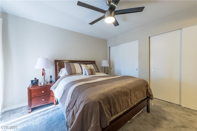 bedroom featuring carpet, two closets, and a ceiling fan