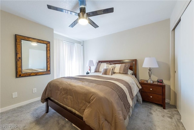 bedroom featuring baseboards, ceiling fan, and light colored carpet