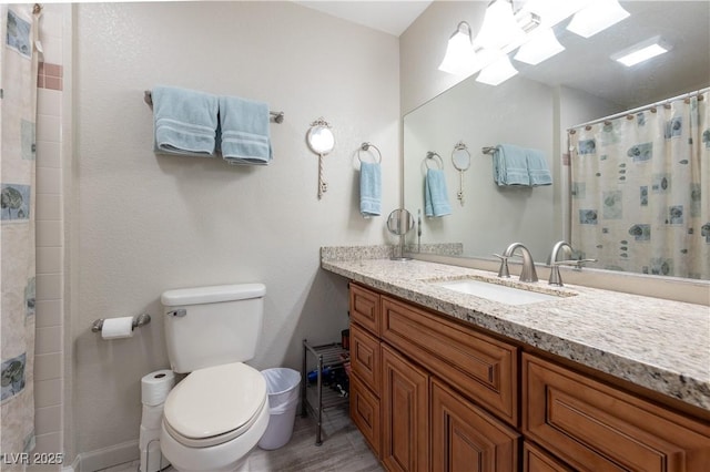 bathroom featuring a shower with shower curtain, vanity, and toilet