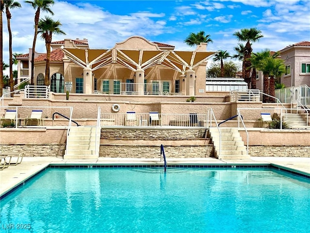 community pool with a patio area