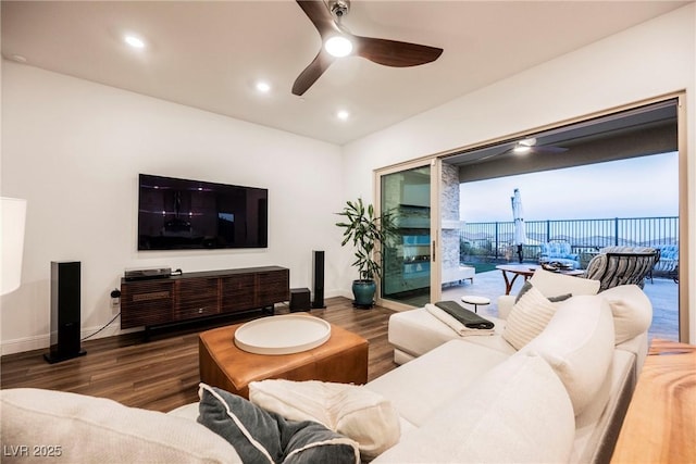 living room with dark wood-type flooring and ceiling fan