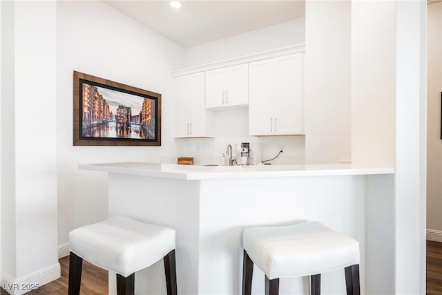 bar with white cabinets, sink, and dark hardwood / wood-style floors