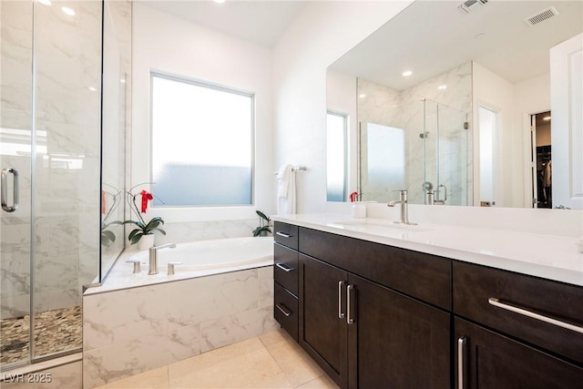 bathroom featuring separate shower and tub, tile patterned flooring, and vanity