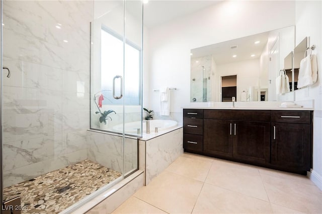 bathroom with vanity, tile patterned floors, and shower with separate bathtub