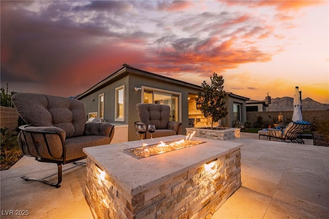 patio terrace at dusk with a fire pit