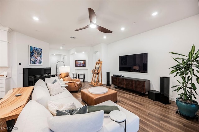 living room featuring ceiling fan and wood-type flooring