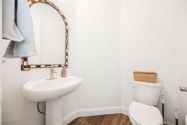 bathroom featuring hardwood / wood-style floors and toilet