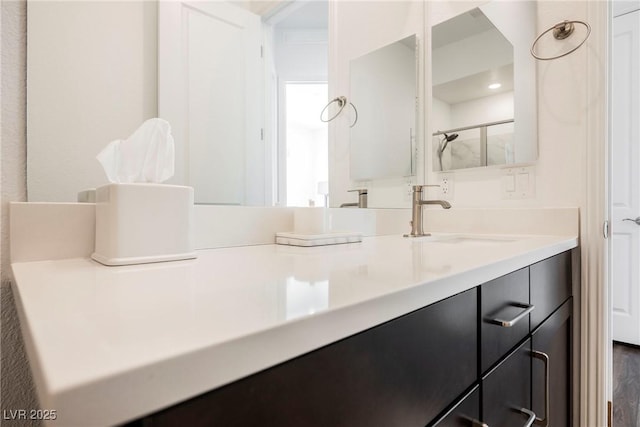 bathroom with vanity and a shower with shower door