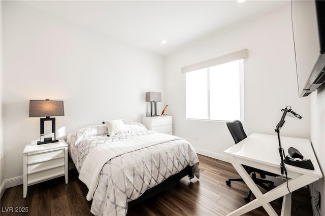 bedroom with dark hardwood / wood-style flooring