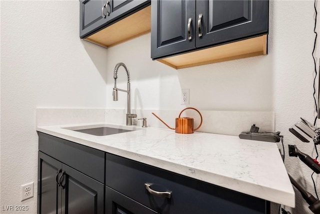 kitchen with sink and light stone countertops