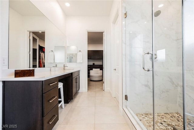 bathroom with tile patterned flooring, an enclosed shower, and vanity