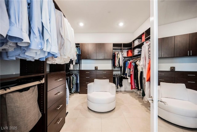 walk in closet with light tile patterned floors