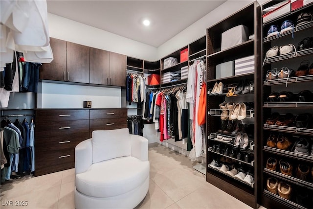 spacious closet with light tile patterned floors