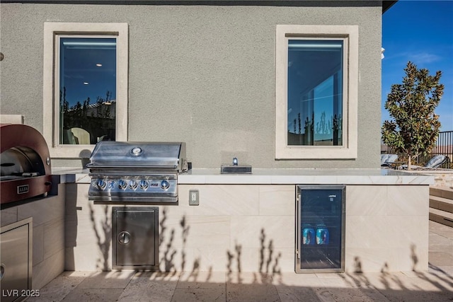 view of patio / terrace with exterior kitchen, grilling area, and wine cooler