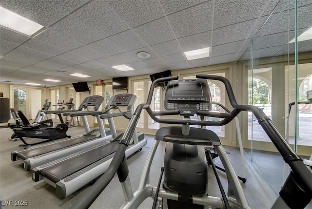 gym with a paneled ceiling