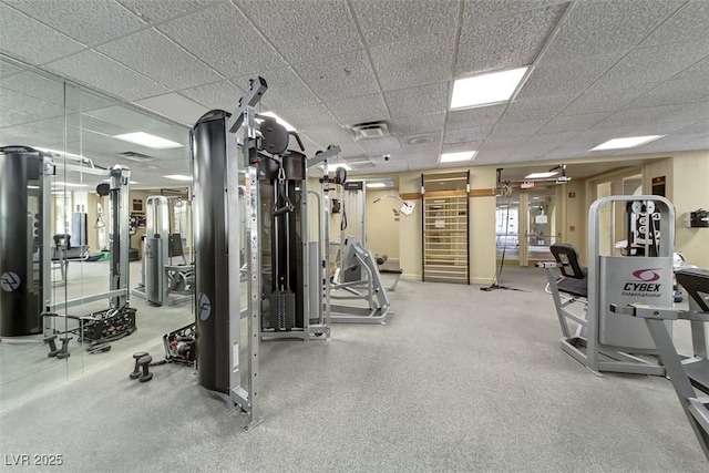 gym with a paneled ceiling and visible vents