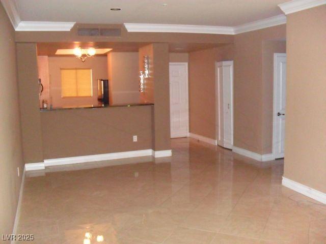 empty room featuring crown molding