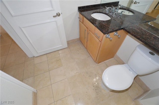 bathroom featuring tile patterned flooring, vanity, and toilet