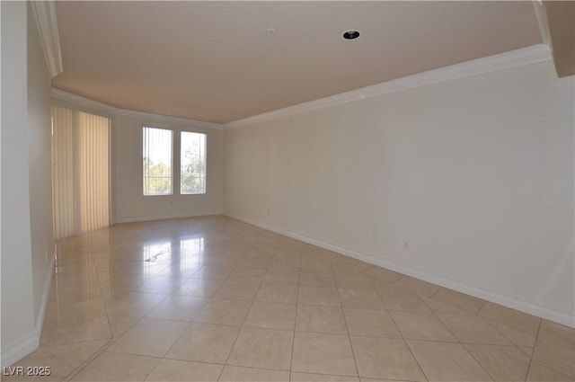 empty room featuring crown molding, baseboards, and light tile patterned floors