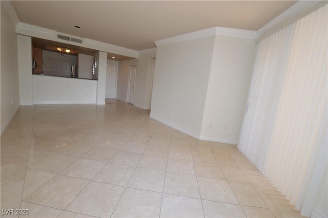 spare room featuring light tile patterned floors, baseboards, visible vents, and crown molding