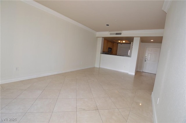 spare room featuring light tile patterned floors, baseboards, visible vents, and crown molding