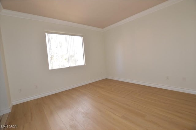 unfurnished room with ornamental molding, light wood-type flooring, and baseboards