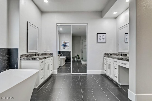 bathroom featuring vanity and shower with separate bathtub