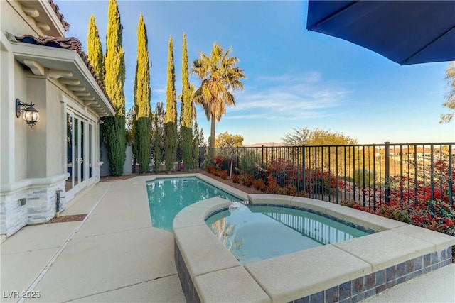 view of swimming pool featuring an in ground hot tub and a patio area