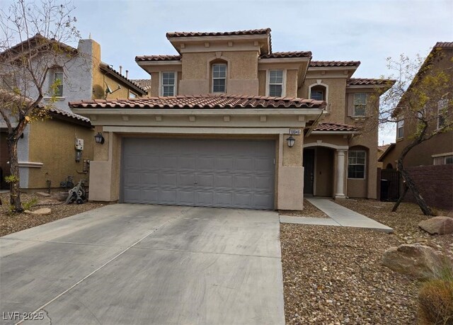 mediterranean / spanish-style home featuring a garage