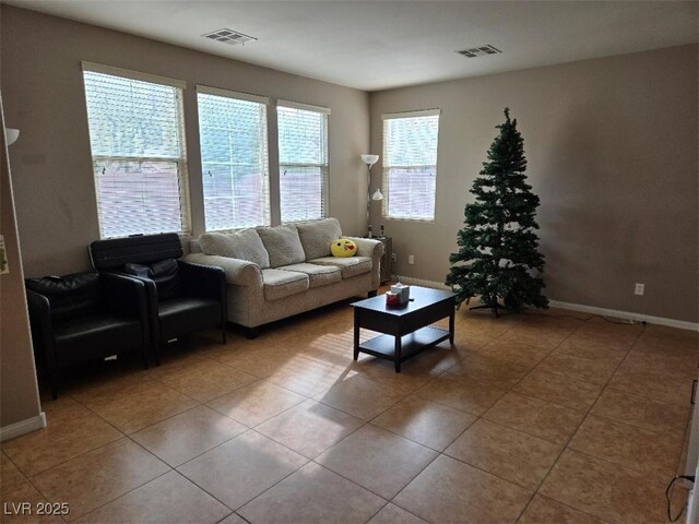 living room with tile patterned floors and a wealth of natural light