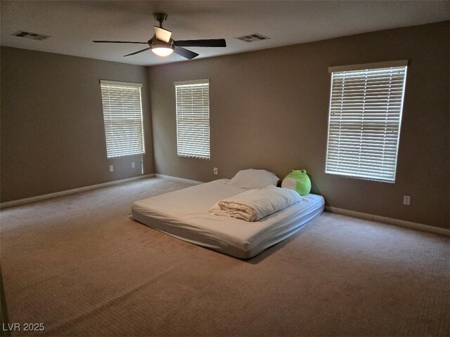 bedroom featuring ceiling fan and light colored carpet