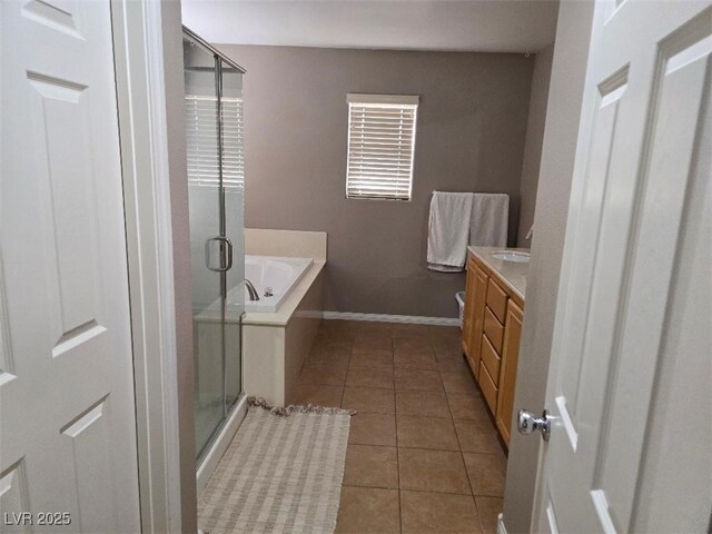 bathroom featuring tile patterned floors, plus walk in shower, and vanity