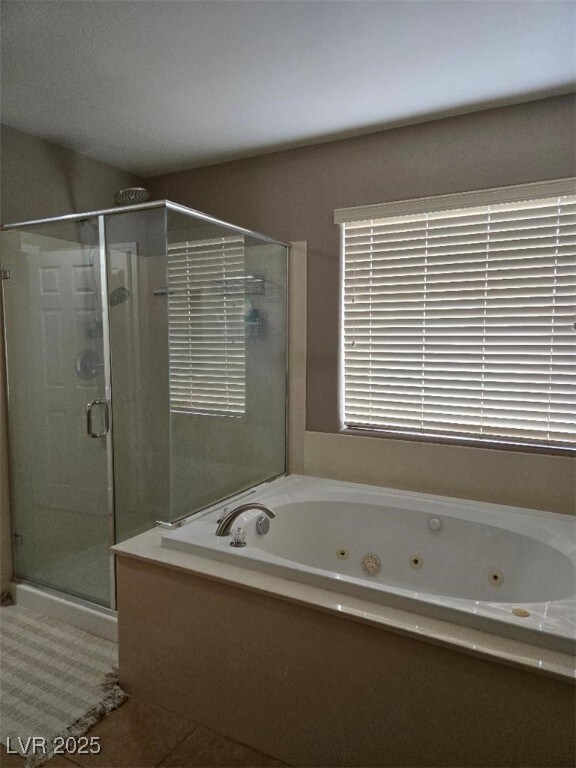 bathroom with tile patterned flooring and plus walk in shower