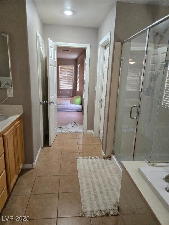 10046 Dancing Lasso Ct, Las Vegas, NV 89178 - full bath with vanity, a stall shower, baseboards, and tile patterned floors