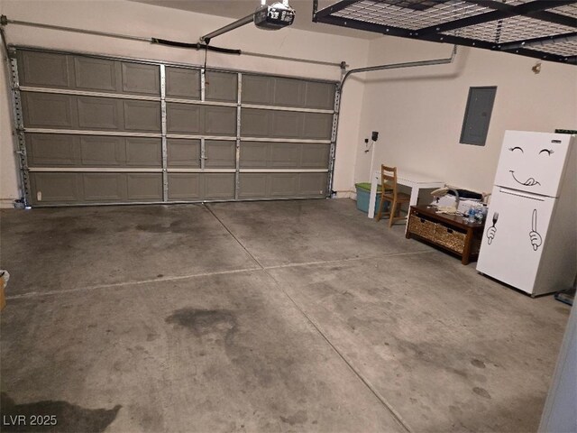 garage featuring white refrigerator, a garage door opener, and electric panel