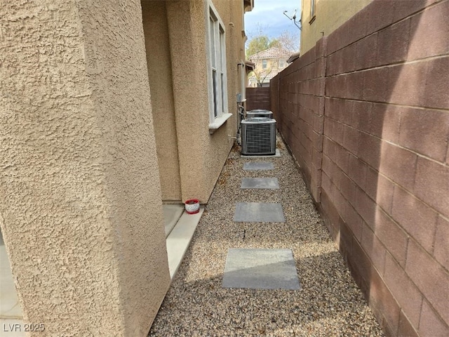 10046 Dancing Lasso Ct, Las Vegas, NV 89178 - view of property exterior with stucco siding and central AC