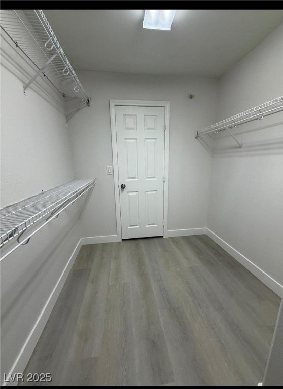 10046 Dancing Lasso Ct, Las Vegas, NV 89178 - walk in closet featuring wood finished floors