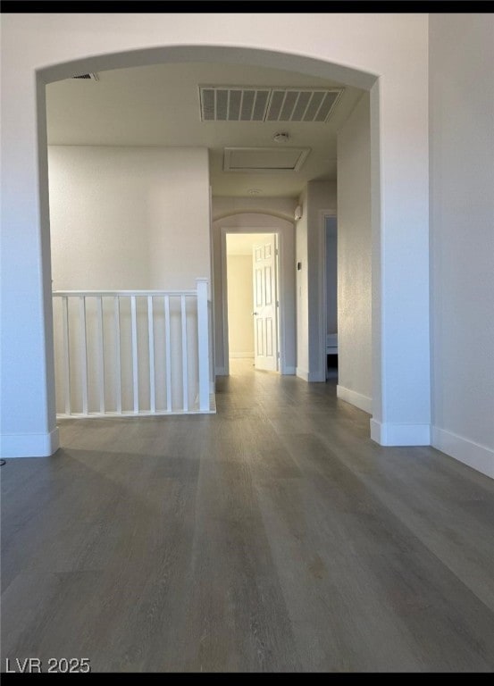 10046 Dancing Lasso Ct, Las Vegas, NV 89178 - unfurnished room featuring wood finished floors, arched walkways, and baseboards