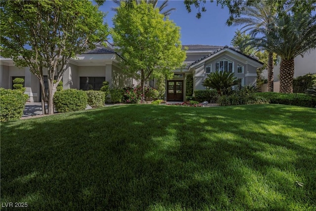 view of front of house featuring french doors and a front yard