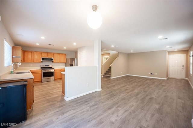 kitchen featuring sink, stainless steel appliances, and light hardwood / wood-style flooring