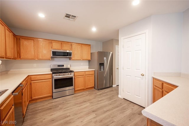 kitchen featuring light wood-type flooring and appliances with stainless steel finishes