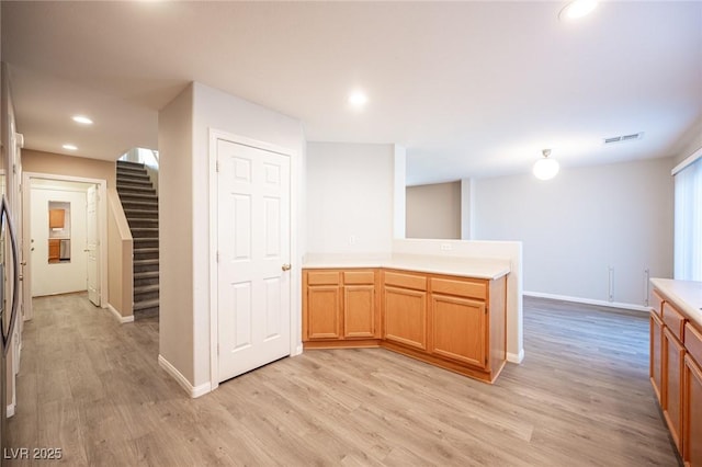 kitchen with light hardwood / wood-style floors and kitchen peninsula