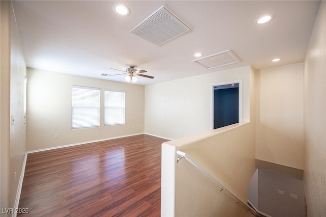 unfurnished room featuring ceiling fan and dark wood-type flooring