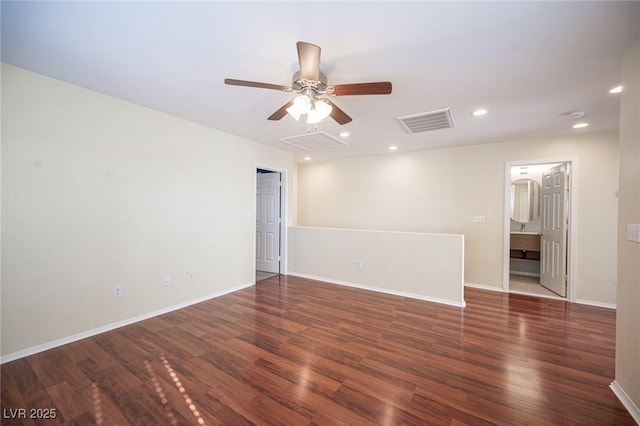 spare room with dark hardwood / wood-style flooring and ceiling fan